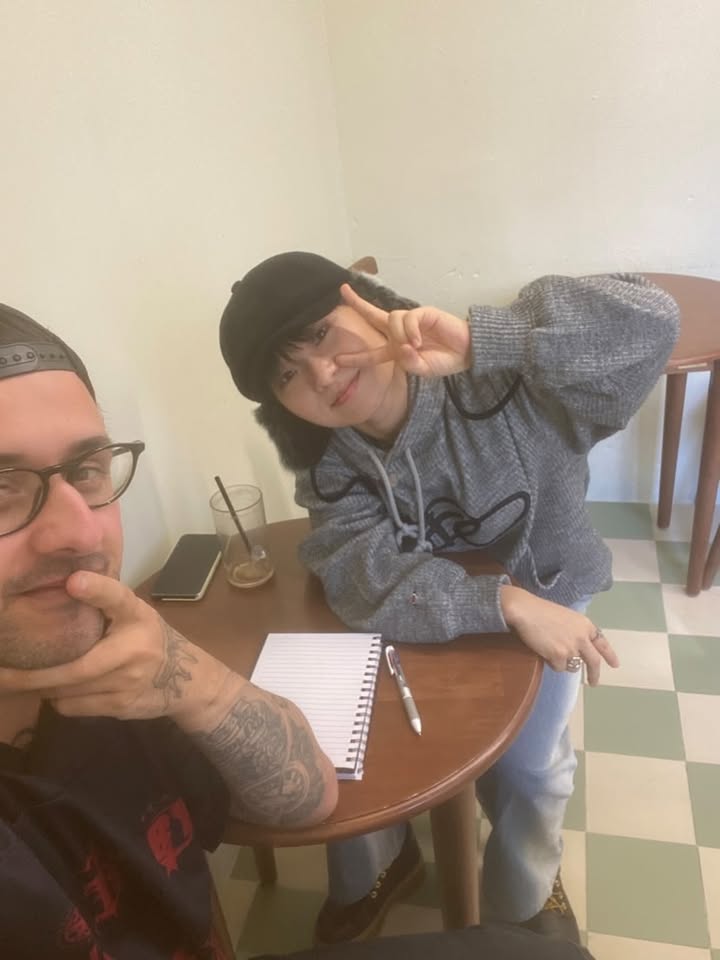 Sam aka CMK and Spark at a cafe table