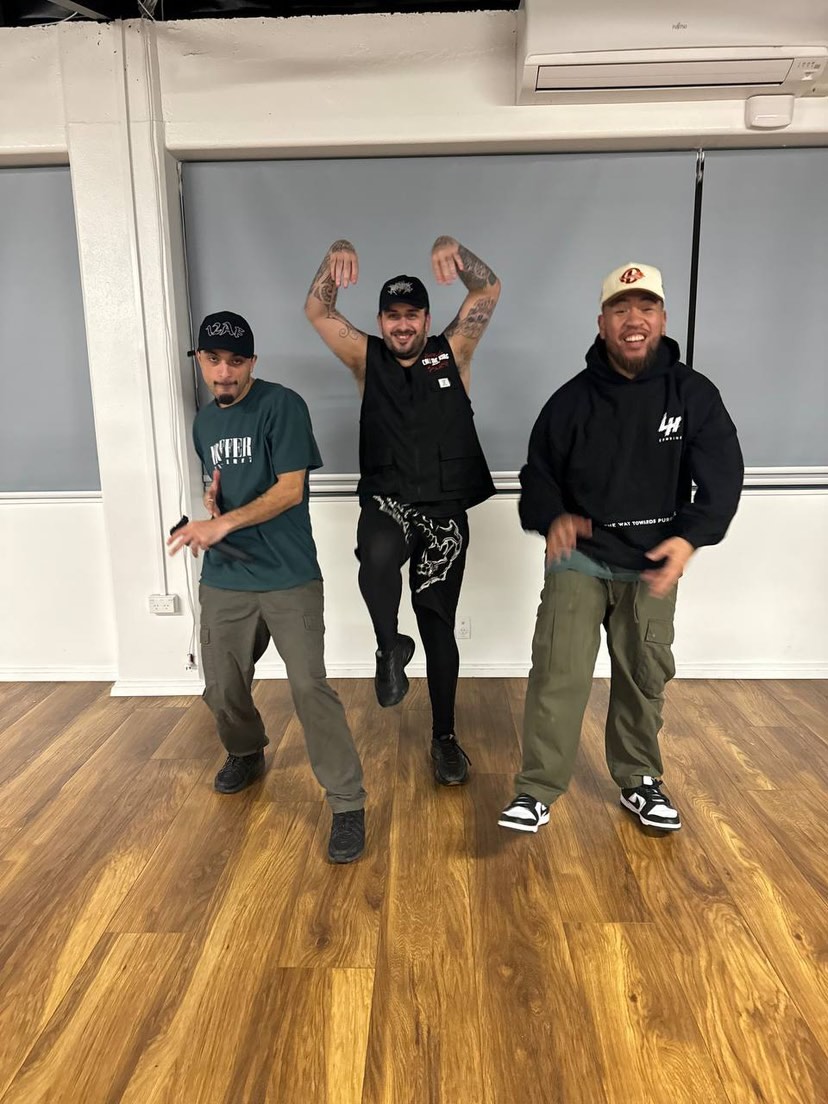 Sam aka CMK dancing with two crew members in a studio